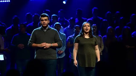 Man and woman singing duet onstage